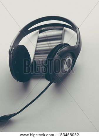 Headphone and Smartphone in Workplace, Isolated Elegance Background