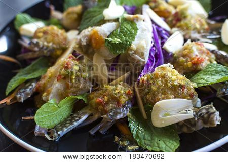 Thai Spicy Sauce on top of raw crabs.