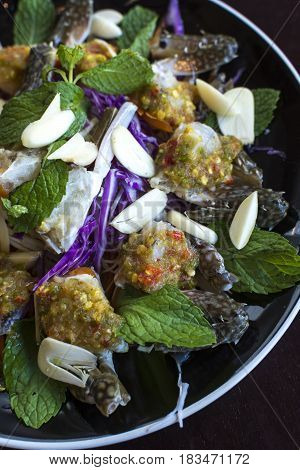 Thai Spicy Sauce on top of raw crabs.