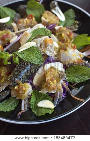 Thai Spicy Sauce on top of raw crabs.