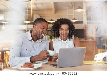Two Businesspeople Meet In Coffee Shop Shot Through Window
