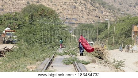 Woman and child walk in Ethiopian desert near Somalia