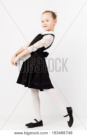 Funny Little Girl Wearing Eyeglasses Imitates A Strict Teacher Against White Background
