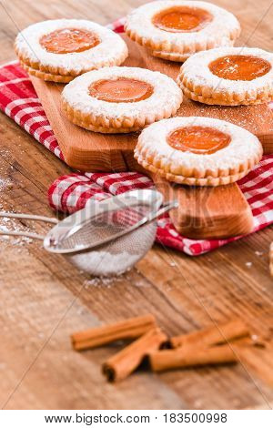 Breakfast cookies with jam on cutting board.