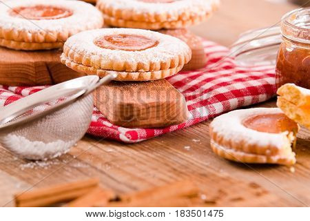Breakfast cookies with jam on cutting board.