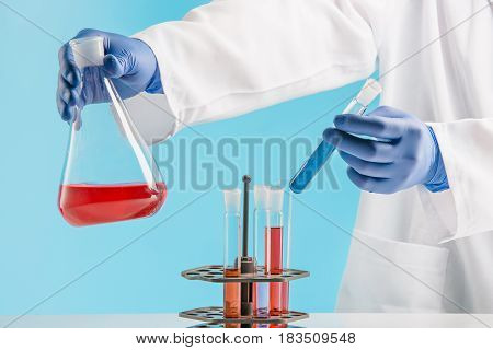 Experiments in a chemistry lab. conducting an experiment in the laboratory with humen hands