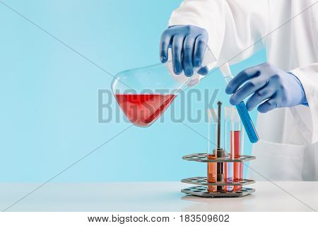 Experiments in a chemistry lab. conducting an experiment in the laboratory with humen hands