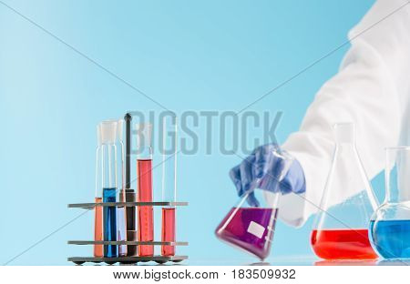 Experiments in a chemistry lab. conducting an experiment in the laboratory with humen hands