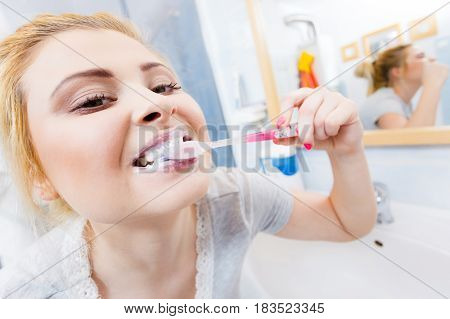 Woman Brushing Cleaning Teeth In Bathroom