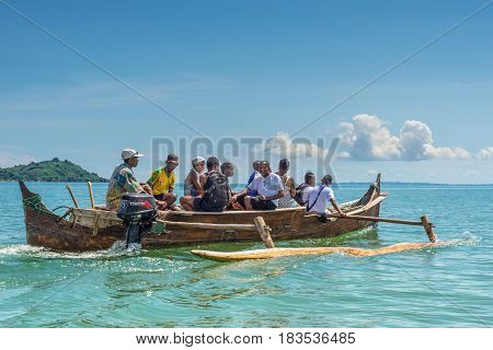 Ambatozavavy Nosy Be Madagascar - December 19 2015: Tourists with a guide crossing the inlets by outrigger canoe near the Ambatozavavy village in Nosy Be island Madagascar Africa.