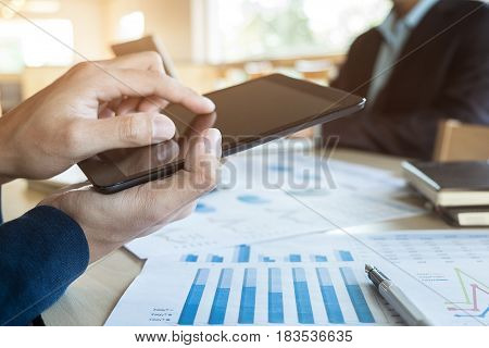 Team job succes. Closeup photo young hands business managers holding tablet working with new startup project in office.Analyze document plan.