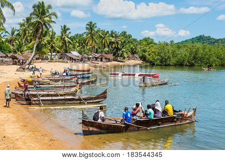 Ambatozavavy Nosy Be Madagascar - December 19 2015: Traditional wood pirogue with outrigger waiting for passengers in the fishing Ambatozavavy village on the Nosy Be island Madagascar.
