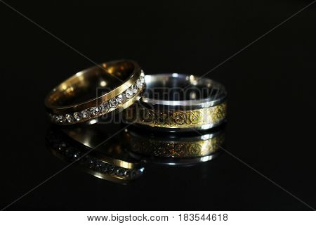 Wedding Rings On A Black Glossy Background