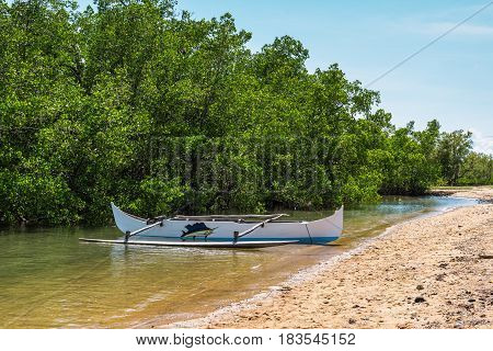 Ambatozavavy Nosy Be Madagascar - December 19 2015: Traditional wood pirogue with outrigger on the shore of the fishing village on the Nosy Be island Madagascar.