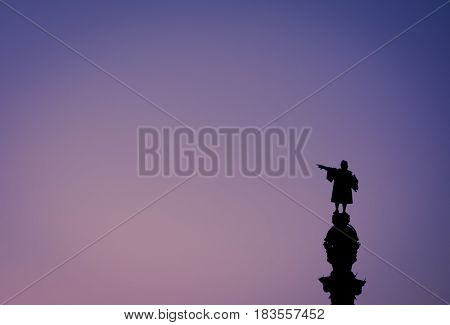 Christopher Columbus statue silhouette over sunset and blue hour clear sky. This is one of the iconic images of Barcelona. Suitable for Columbus day