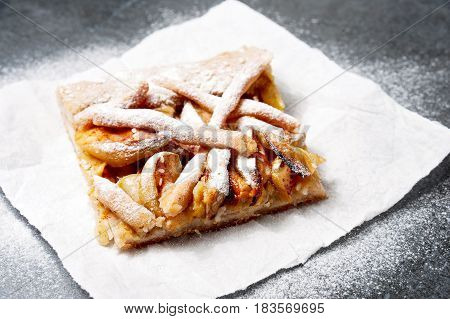 Apple Pie on disposable paper plate. Double crust apple pie with cinnamon made with shortcrust pastry closeup