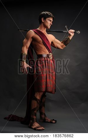 The buff highlander is showing off his sword.
