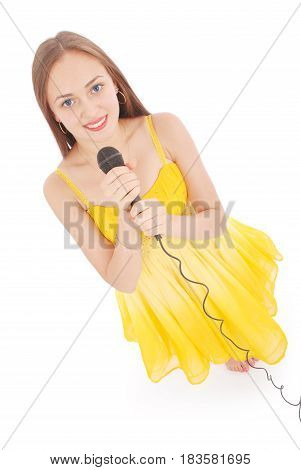 Happy young beautiful girl singing with microphone isolated on white background