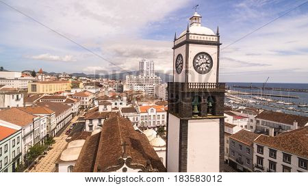 Saint Sabastian church with clock tower in Ponta Delgada on Sao Miguel Island in Azores, Portugal. Beautiful church in early morning under white clouds.