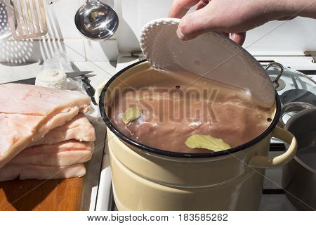 Preparation raw meat for smoking. Pork neck meat and bacon. Picking raw meat in brine. Soaking of meat in brine