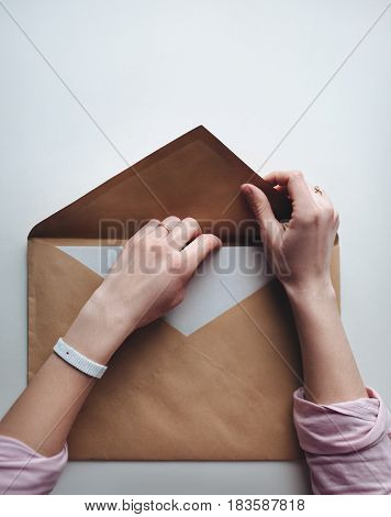 Big brown vintage envelope with woman hands.