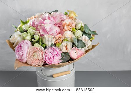 Still life with a bouquet of flowers. the florist put together a beautiful bunch of flowers. Man manual work used different types of flowers and colors.