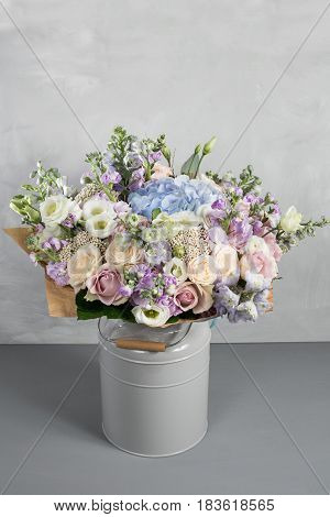 Still life with a bouquet of flowers. the florist put together a beautiful bunch of flowers. Man manual work used different types of flowers and colors.