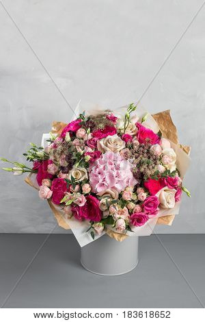 Still life with a bouquet of flowers. the florist put together a beautiful bunch of flowers. Man manual work used different types of flowers and colors.