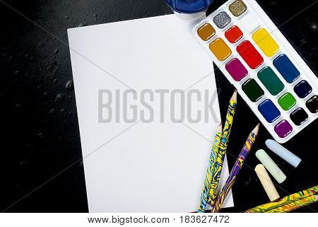 Watercolors And Pencils On A Black Background. Top View. Copy Space.