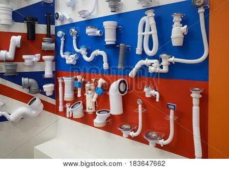 Plastic plumbing pipes and fittings for sewage system displayed in the store