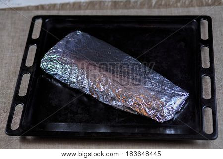 Fillet Is Fresher Than Fish Wrapped In A Foil On A Black Background