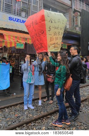 TAIPEI TAIWAN - DECEMBER 5, 2016: Unidentified people fly sky lantern in Shifen town. Shifen is an old railroad town and popular tourist destination.