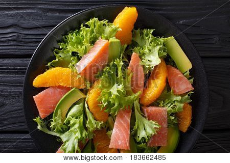 Delicatess Salad Of Salted Salmon, Oranges, Avocado And Lettuce Close-up. Horizontal Top View