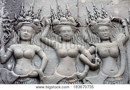 Ancient reliefs with Apsaras at Angkor Wat temple, Cambodia. Angkor Wat was built between 1113 and 1150 by King Suryavarman II.