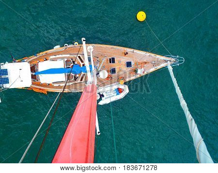 Looking down at the sailboat from the top of the mast