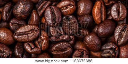 Coffee beans background macro. Dark Roasted coffee beans textured wal lpaper for your design with copy space