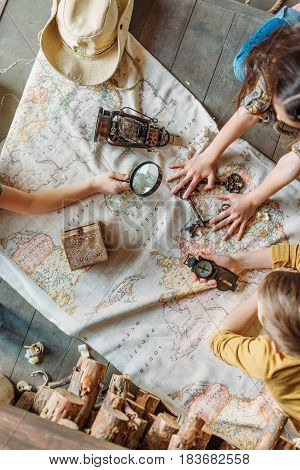 Overhead View Of Little Kids Travelers Sitting Together On Porch With Map