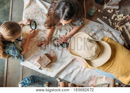 Overhead View Of Little Kids Travelers Sitting Together On Porch With Map