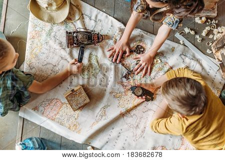 Overhead View Of Little Kids Travelers Sitting Together On Porch With Map