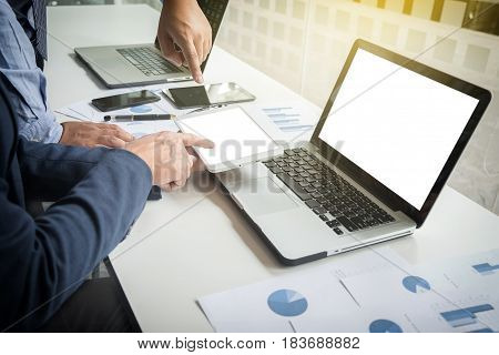 Teamwork process Businessmen hands pointing at tablet and document during explanation of new plan project data at meeting.