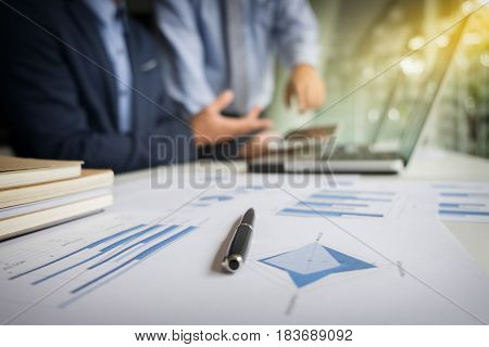 Teamwork process blur background Businessmen hands pointing at tablet laptop and document during explanation of new plan project data at meeting.