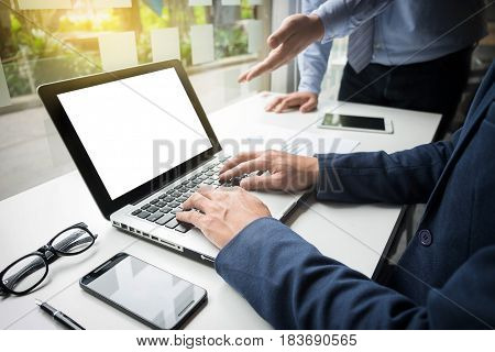 Teamwork process Businessmen hands pointing at laptop and document during explanation of new plan project data at meeting.