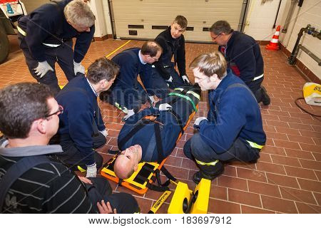 Hamburg, Germany - February 07, 2013: German firefighter team in an exercise with a injured in a stretcher