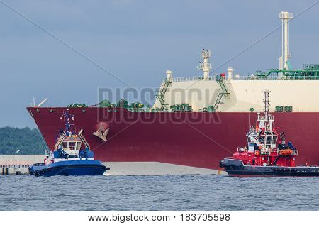 LNG TANKER, TUG AND FIREBOAT-  Gas Carrier safety secured by fireboat at the gas terminal in the port