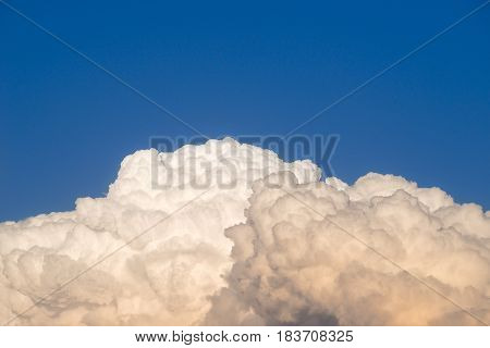 Storm clouds building in the early evening sky at sunset