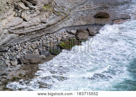 waves breaking into the shore in the late afternoon
