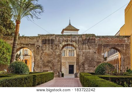 Courtyard at the entrance to Alcazar of Seville with wall from XI century Spain