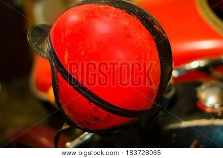 Vintage red motorcycle helmet in the garadge