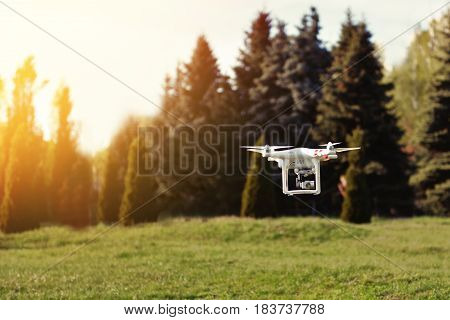 Ukraine Poltavskaya region Kremenchuk - April 26 2017. Quadrocopter flies in the air at sunset. Launching a quadrocopter in the park