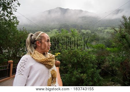 Beautiful young blond contemplative woman in a forest enjoying nature